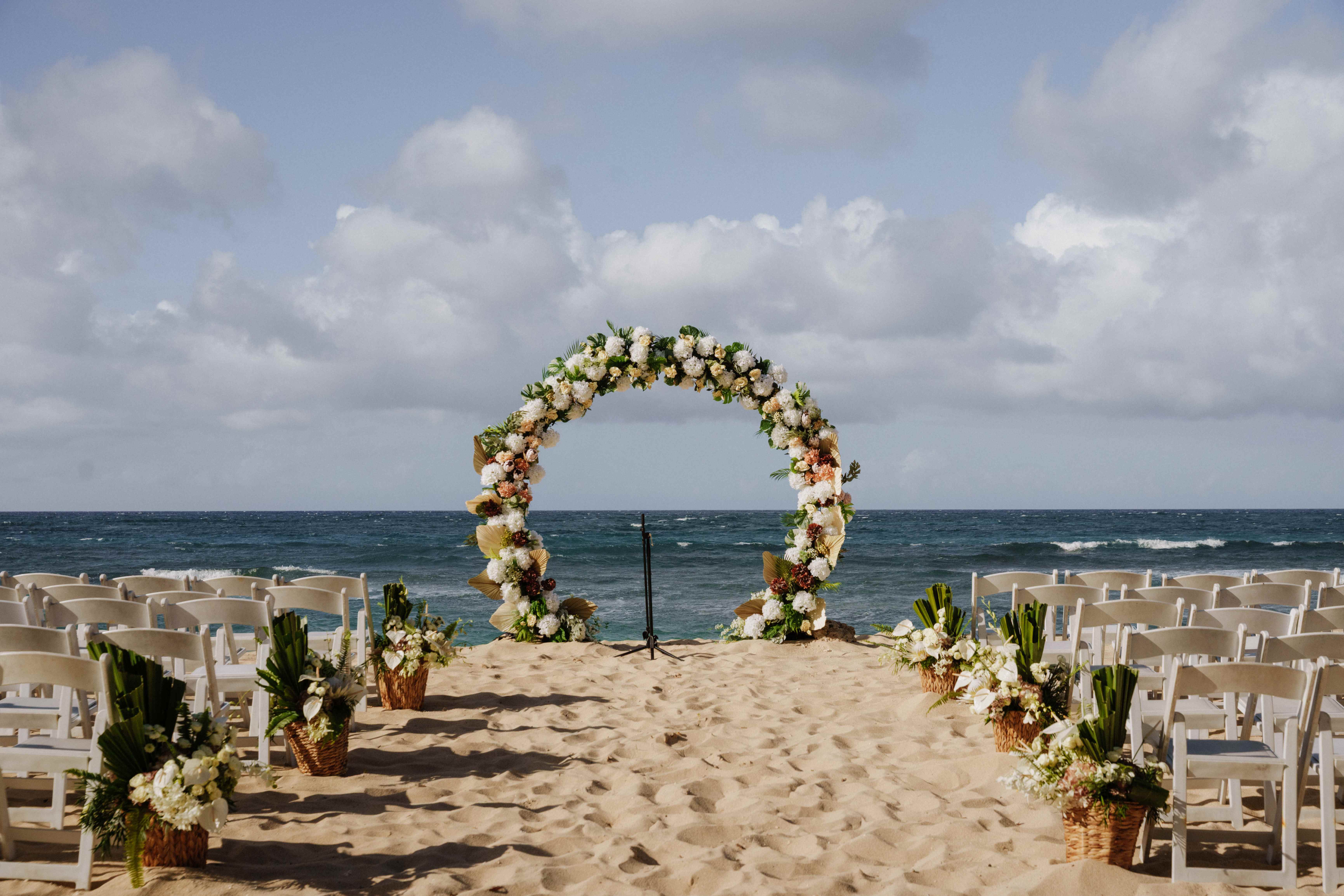 Beach ceremony setup with a floral arch at Six Senses, Uluwatu