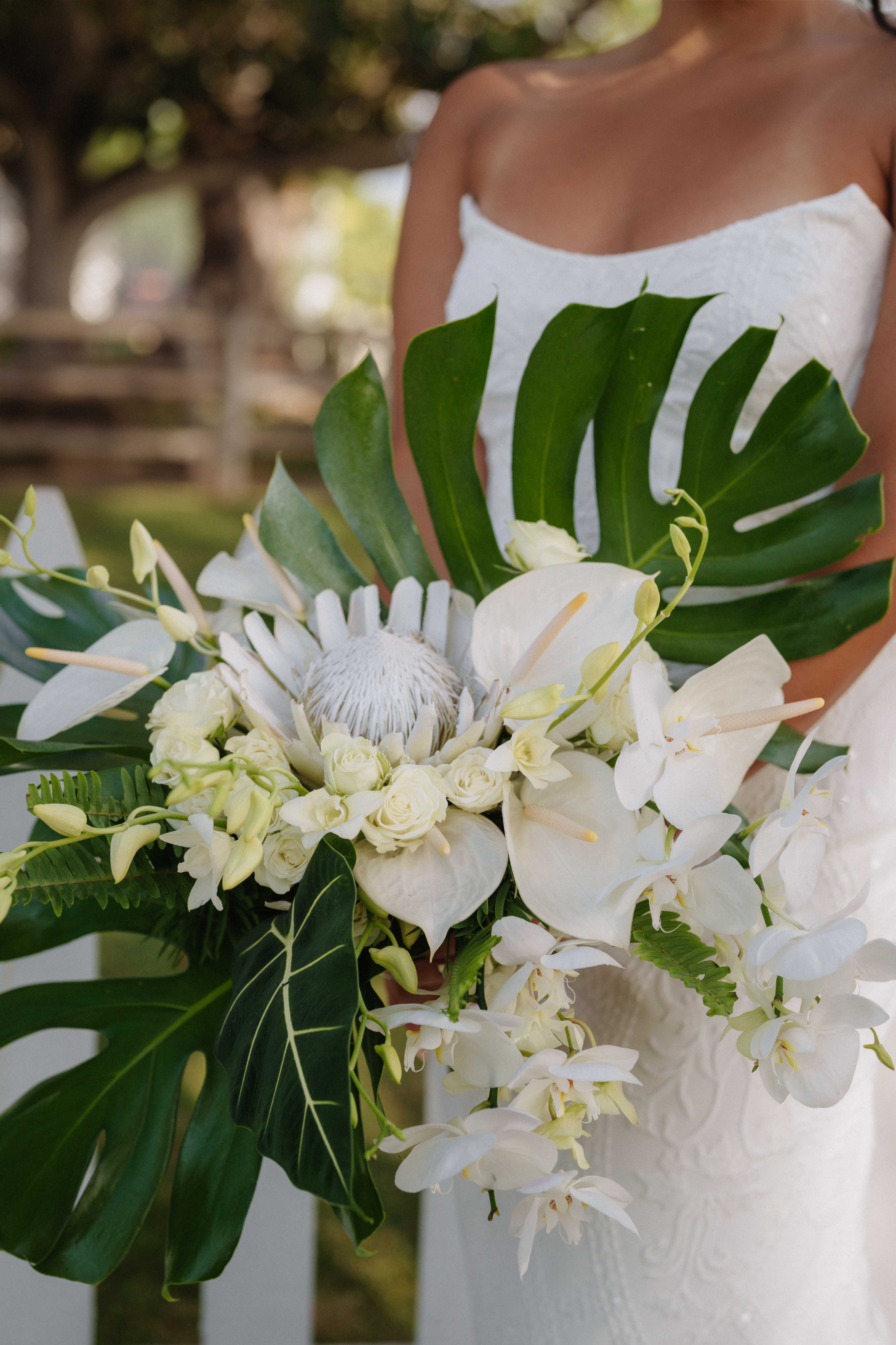 Tropical wedding bouquet with monstera leaves at Villa Vedas, Tabanan