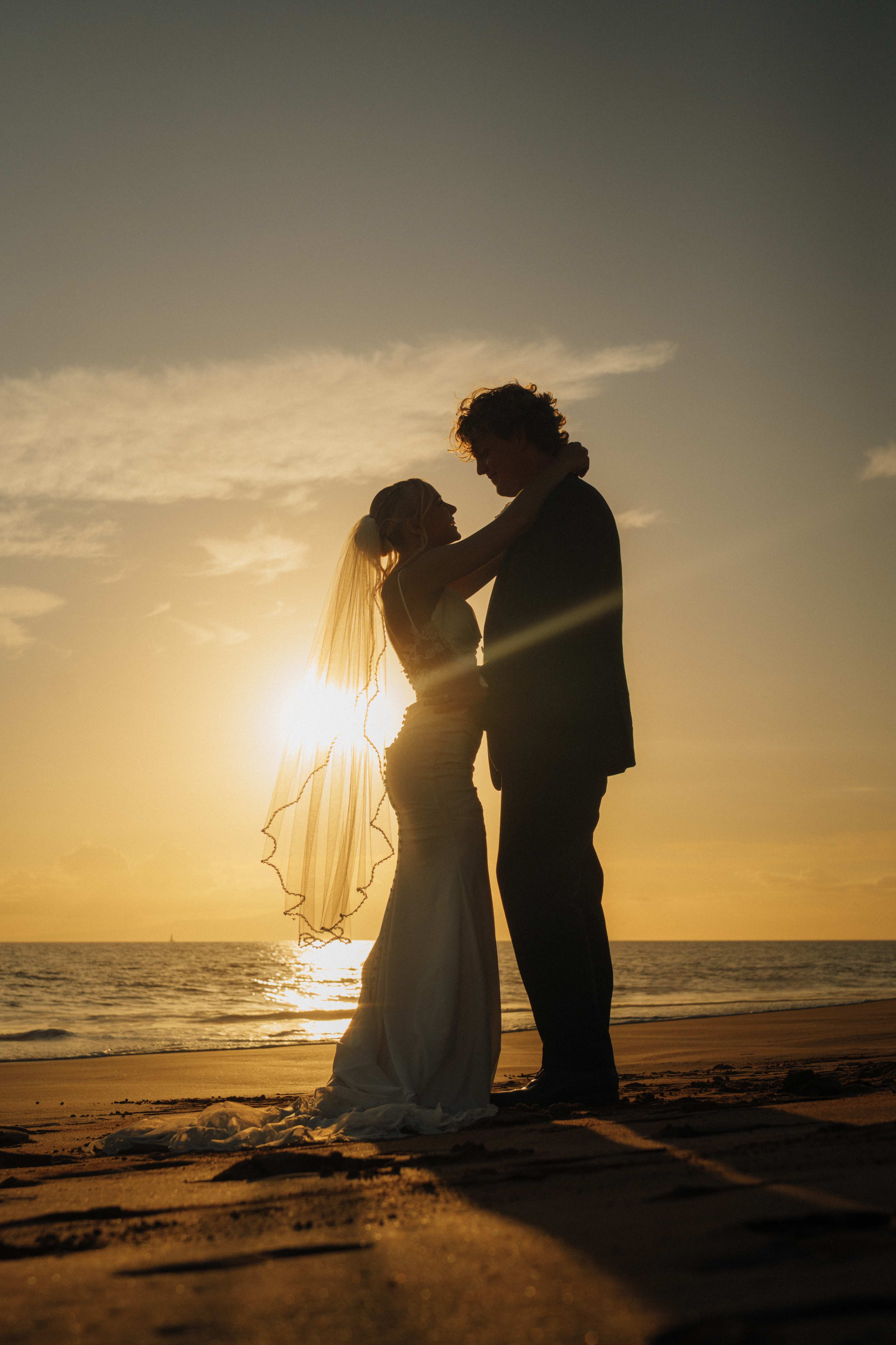 Couple silhouette at golden hour sunset on the beach at Six Senses, Uluwatu